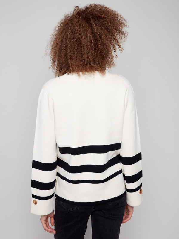 Sophisticated ecru V-neck sweater adorned with side buttons and distinctive wide cuffs by Charlie B.