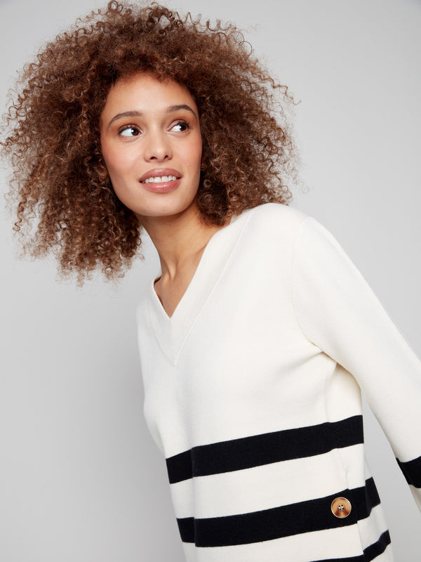 Stylish ecru striped sweater accentuated with buttons at the sides and a classic V-neckline by Charlie B.