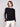 Elegant black sweater featuring intricate crochet sleeves, perfect for a stylish look by Charlie B.