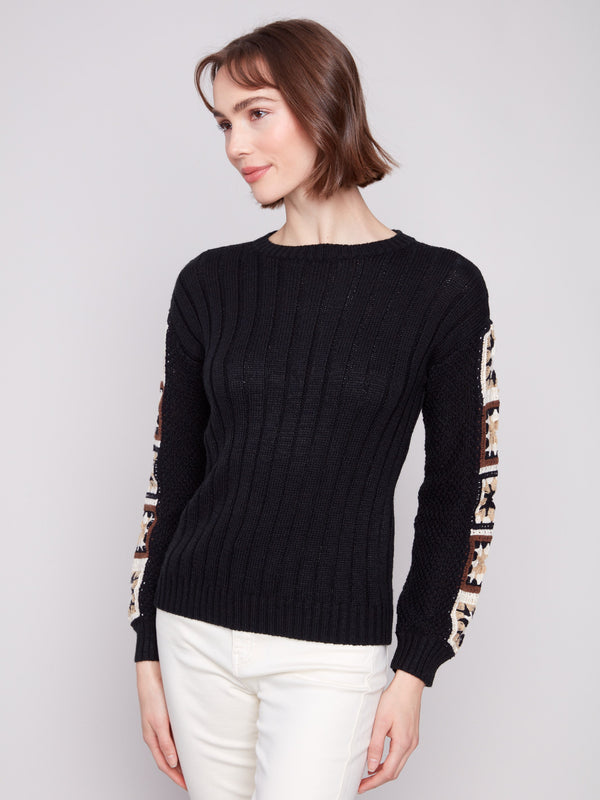 Sophisticated black sweater highlighting a crew neckline and detailed crochet sleeves by Charlie B.