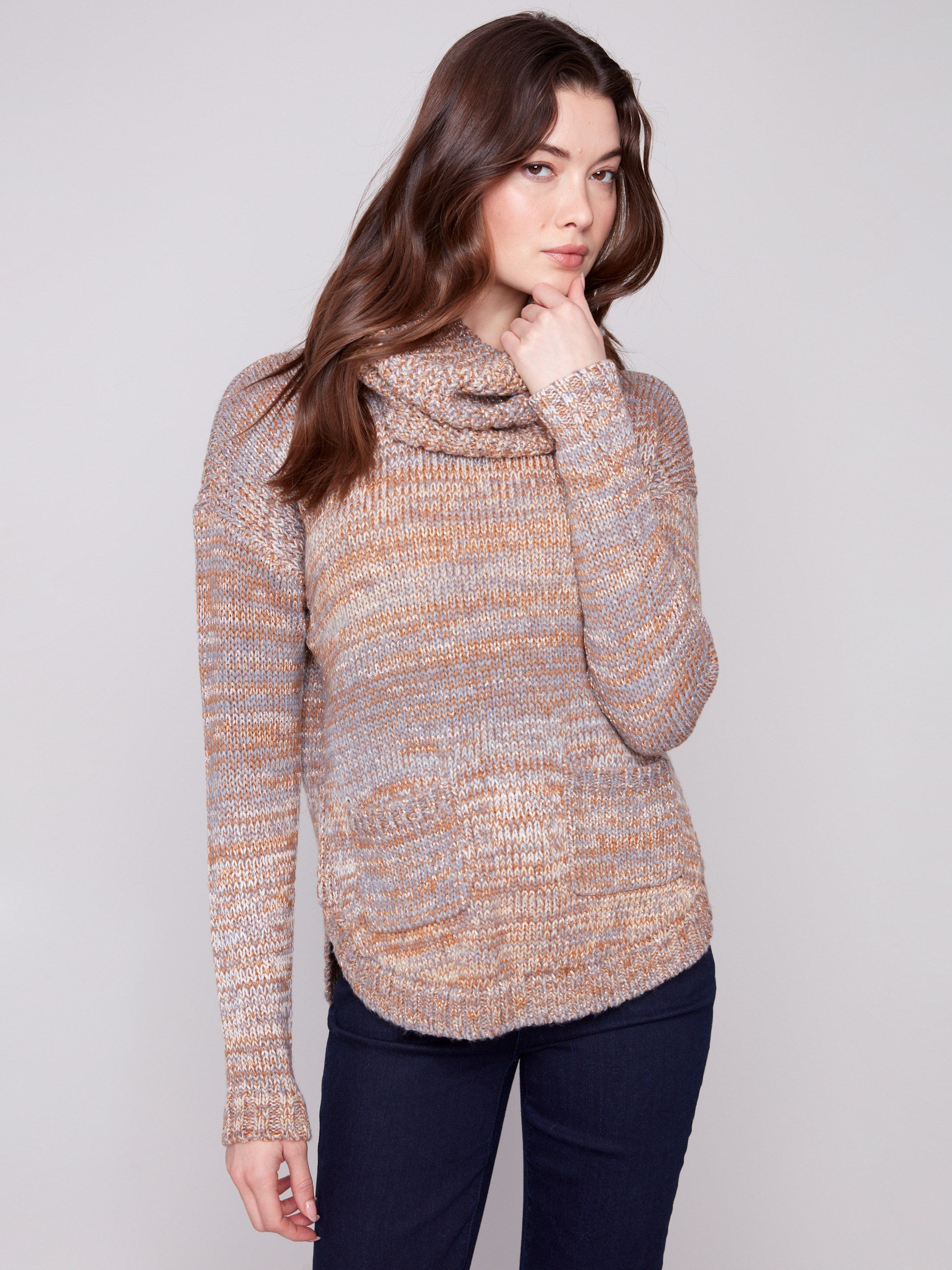 Sweater with a removable scarf, showcasing its cozy texture and round hem design by Charlie B.