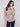 Sweater with a removable scarf, showcasing its cozy texture and round hem design by Charlie B.