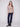Full view of fog-colored sweater with front pockets and a round hem paired with dark jeans by Charlie B.