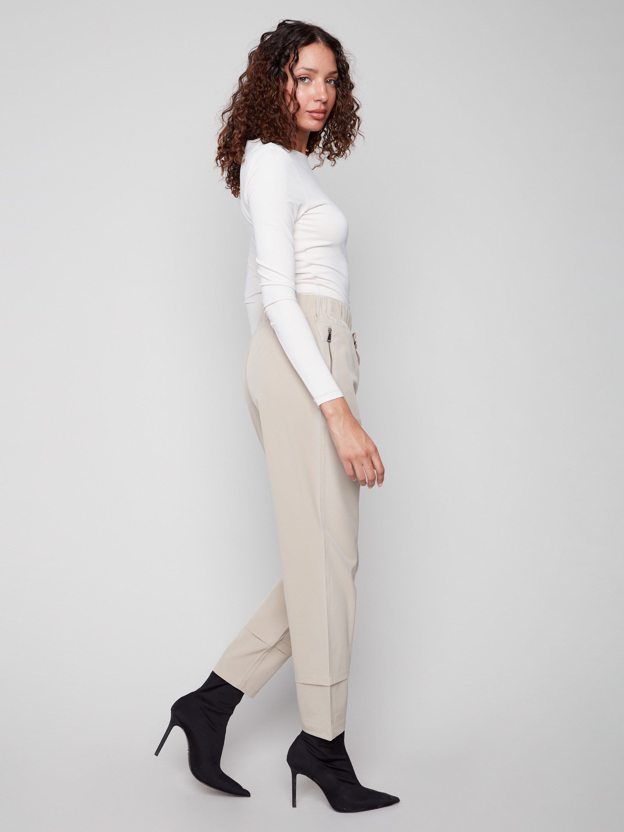 Experience the greige slim-leg techno pants designed with cuff detail, combining style and functionality effortlessly by Charlie B.