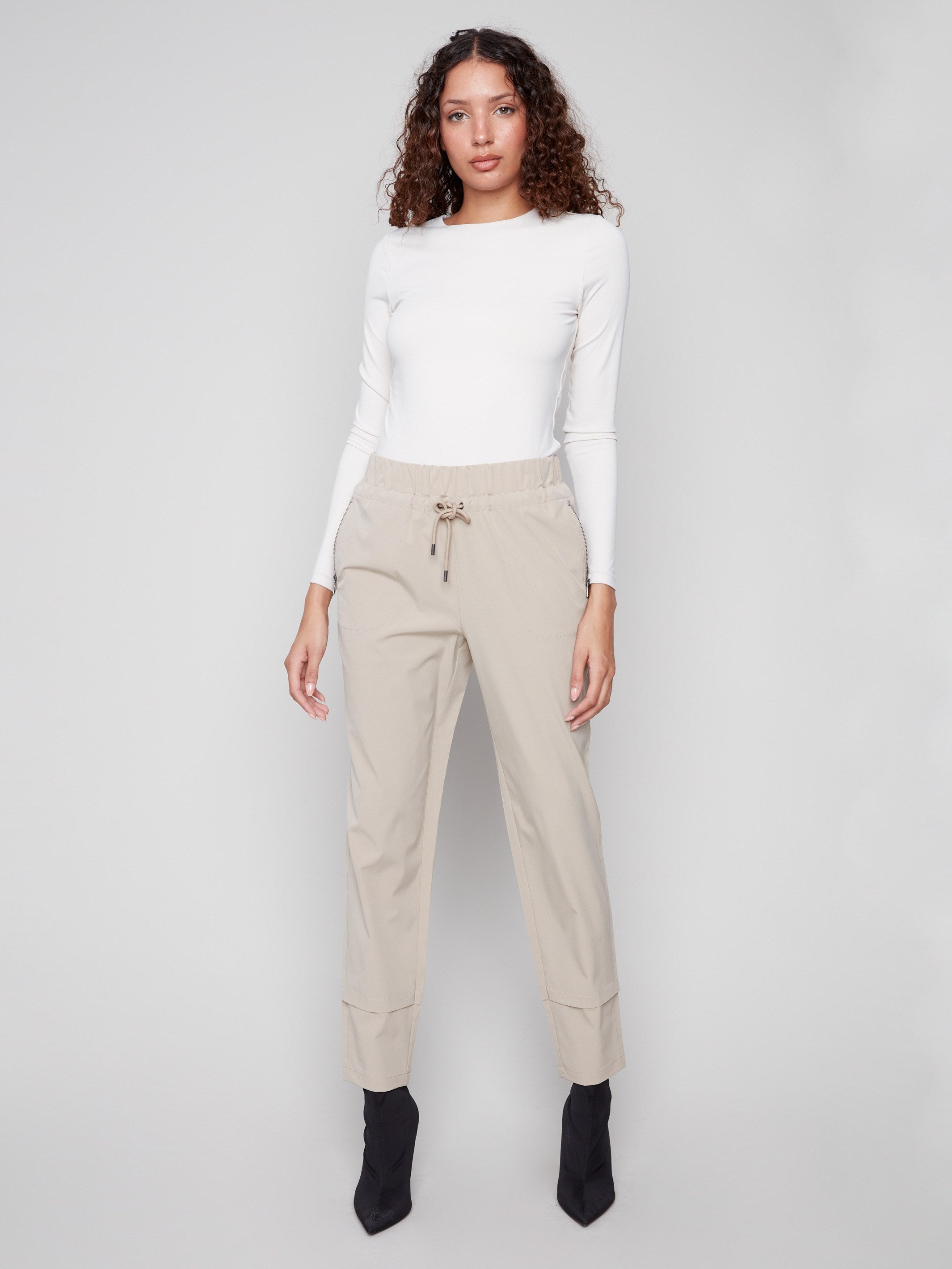 Greige slim-leg techno pants crafted in a pull-on style, complete with an elastic waistband and adjustable drawcords by Charlie B.