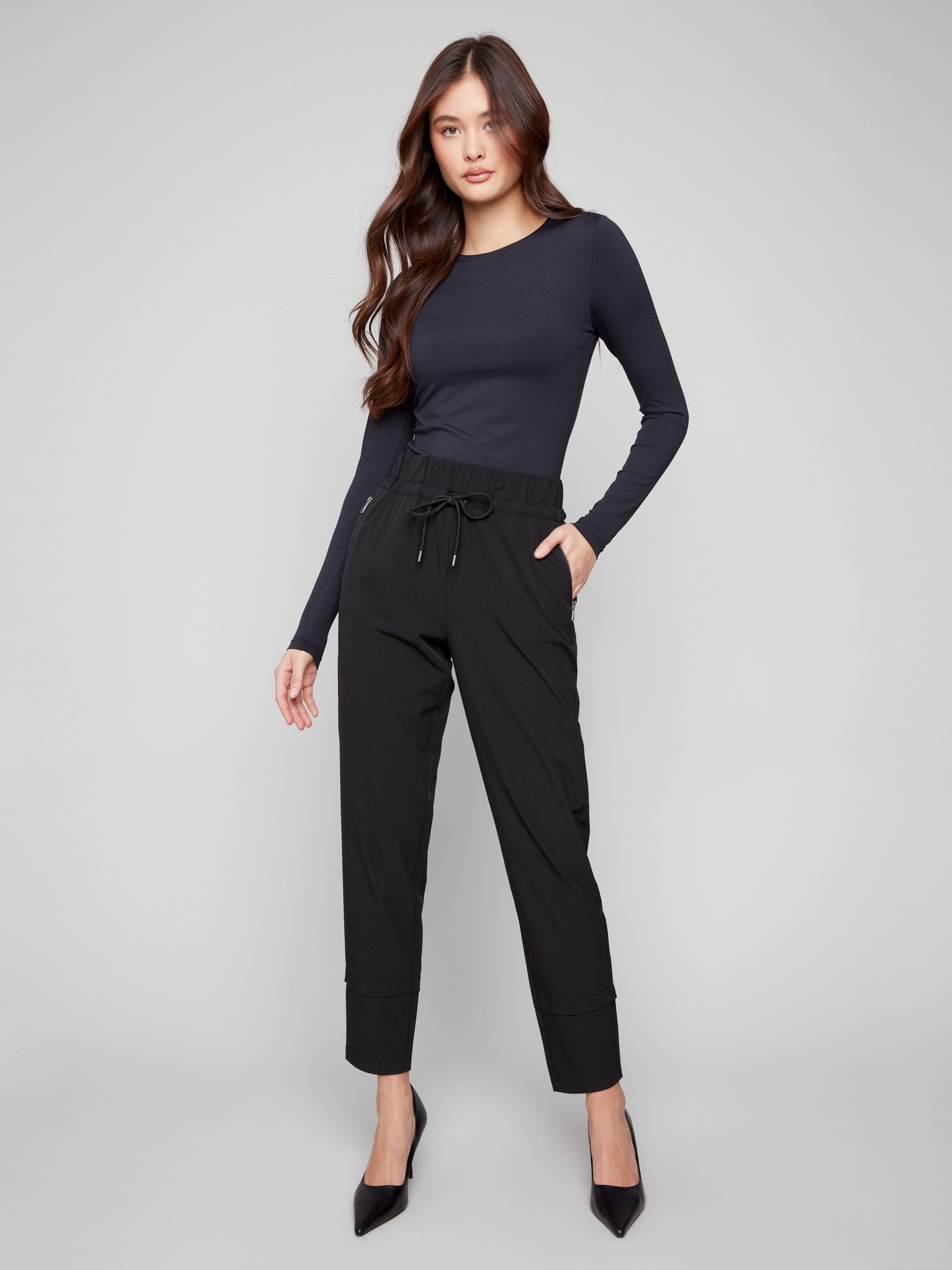Black slim-leg techno pants featuring a relaxed fit and pull-on style with drawstring by Charlie B.