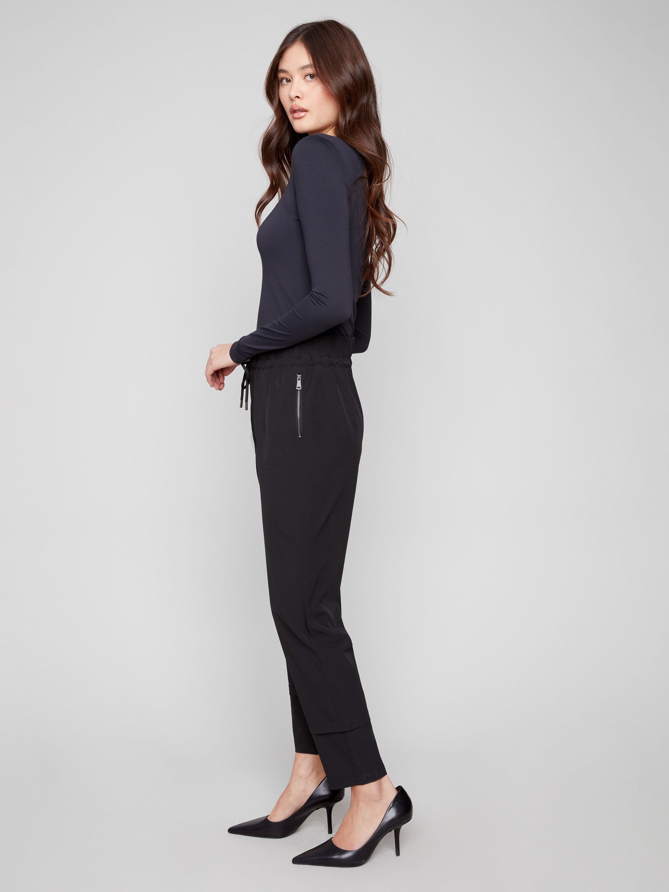 Slim-leg black techno pants with a stylish pull-on design and adjustable drawstring waist by Charlie B.