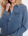 Featuring a half snap-button closure, this denim shirt combines ease of wear with fashionable flair, making it a great addition to your closet by Charlie B.