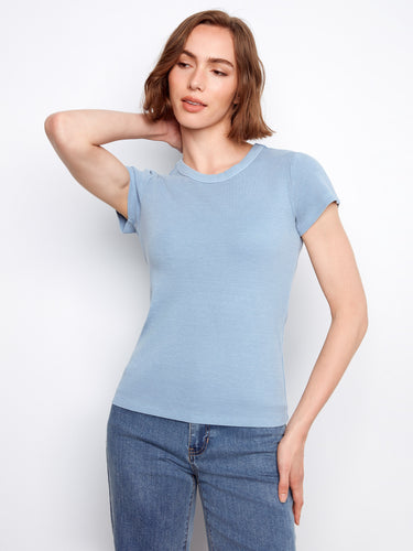 Stylish blue top featuring a comfortable crew neck design, ideal for everyday wear with jeans or skirts. By Charlie B.