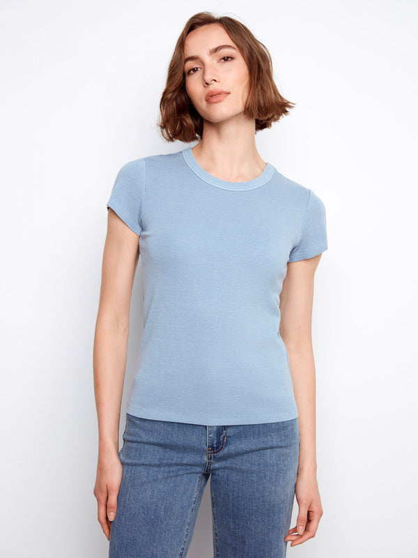 Ribbed-textured blue tee in a semi-fitted style, perfect for pairing with denim or under jackets for added flair. By Charlie B.