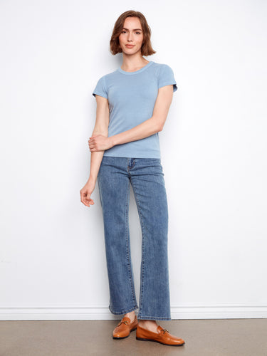 Casual yet refined blue shirt crafted in ribbed fabric, offering versatility and comfort throughout the day. By Charlie B.