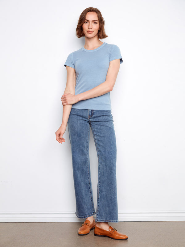 Casual yet refined blue shirt crafted in ribbed fabric, offering versatility and comfort throughout the day. By Charlie B.