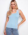 Light blue tank top with a scoop neckline, paired with jeans. The ribbed texture adds a stylish touch to the outfit by Charlie B.
