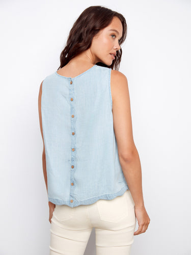 The decorative back buttons add a charming touch to this stylish top, enhancing its overall appeal. By Charlie B.