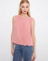Pink sleeveless top featuring a loose fit for relaxed comfort, ideal for casual outings. By Charlie B.