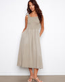 This dress features a maxi length design with a flattering scoop neckline, perfect for any occasion. By Charlie B.