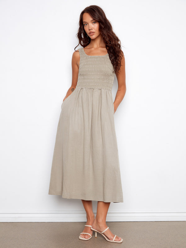 This dress features a maxi length design with a flattering scoop neckline, perfect for any occasion. By Charlie B.