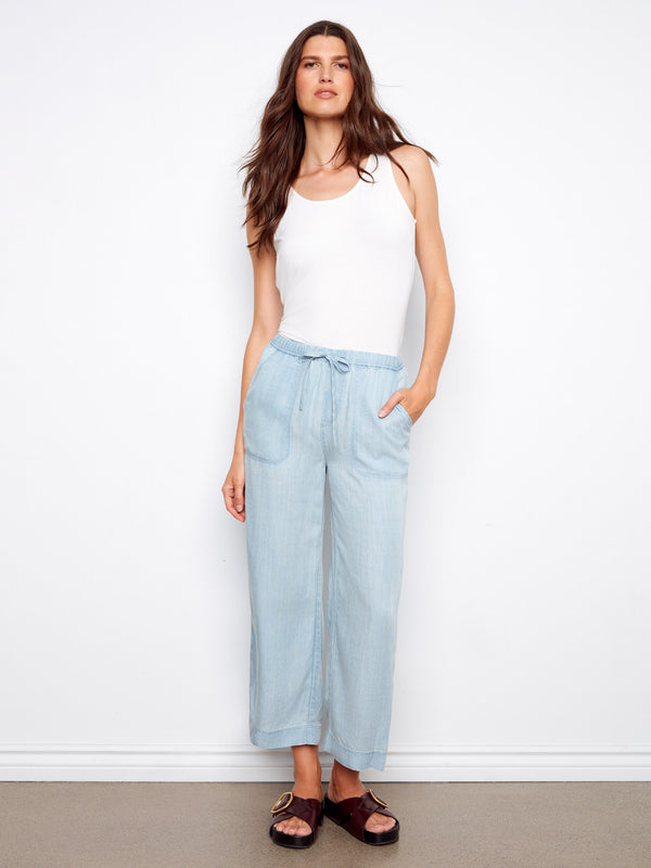 Light blue jogger pants in a cropped length with adjustable drawstrings, crafted from soft Tencel fabric by Charlie B.