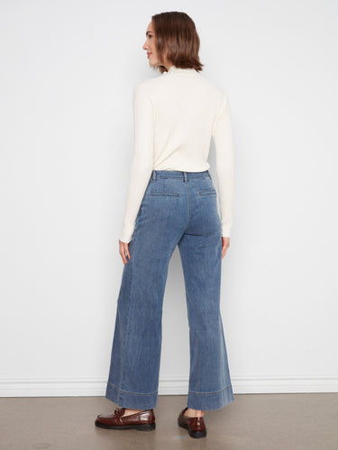The medium blue wide-leg pants come with practical slash pockets for added convenience by Charlie B.