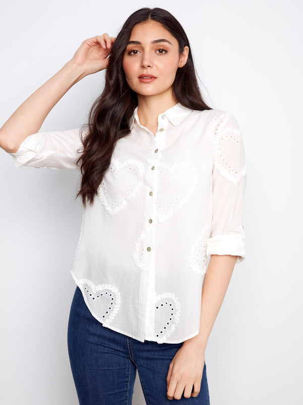 Stylish button-down design adds versatility to this chic white shirt, ideal for any occasion. By Charlie B.