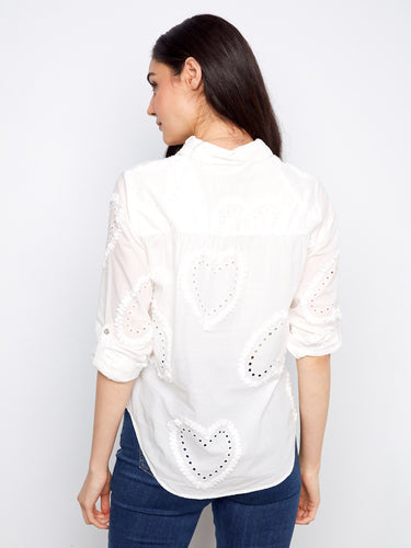 Convenient adjustable roll-up sleeves offer flexibility and style in this lovely white shirt design. By Charlie B.