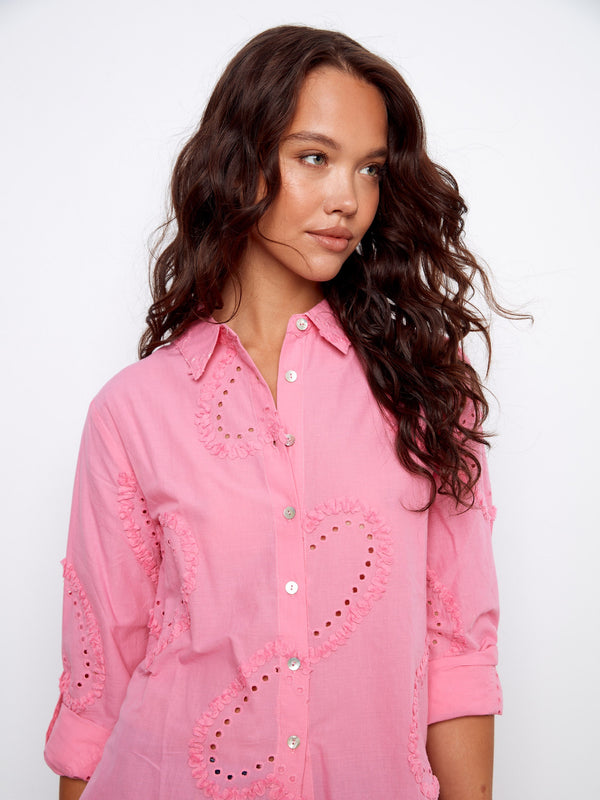 Button-down pink blouse with charming eyelet accents and adjustable sleeves for versatile wear by Charlie B.