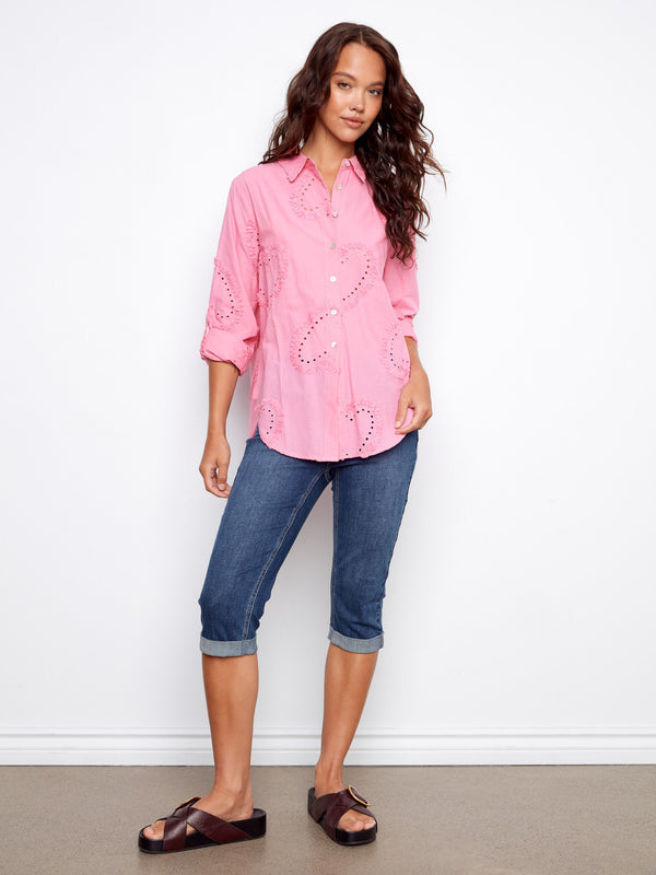 Chic pink cotton blouse showcasing elegant eyelet details and a comfortable button-down design by Charlie B.