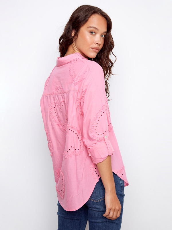 Stylish pink blouse with adjustable roll-up sleeves and detailed eyelet patterns, ideal for any occasion by Charlie B.