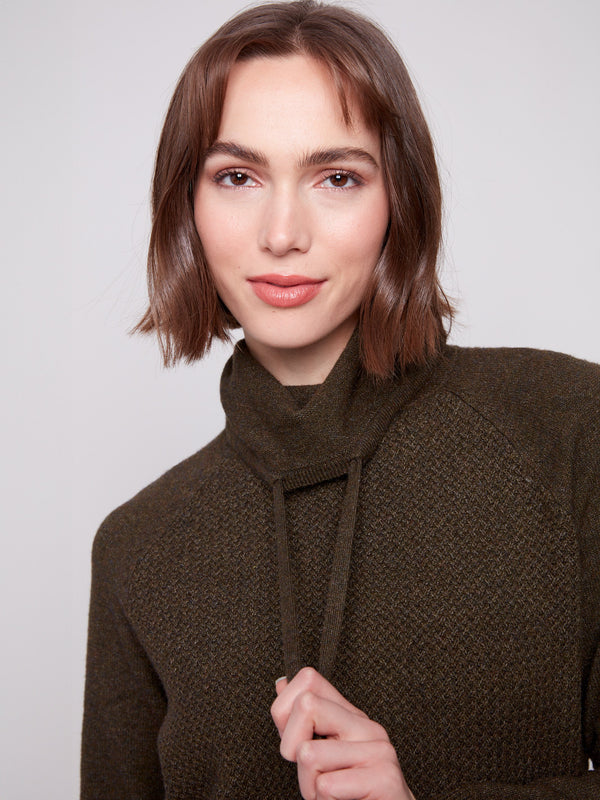 Featuring stylish raglan sleeves, this spruce knit sweater offers a relaxed fit and comfort by Charlie B.
