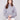 Knit sweater in heather grey featuring a stylish cowl neck with drawstring detail by Charlie B.