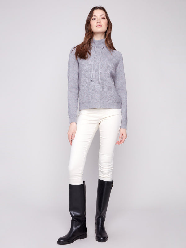 Textured knit pattern adds depth to this sophisticated heather grey sweater by Charlie B.