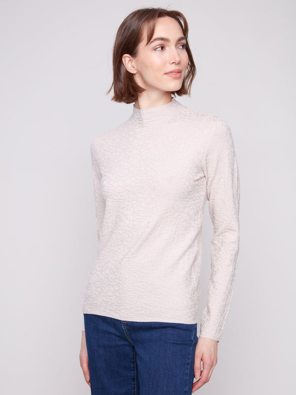 Long-sleeve oat sweater in textured fabric, paired effortlessly with blue jeans for a sleek appearance by Charlie B.