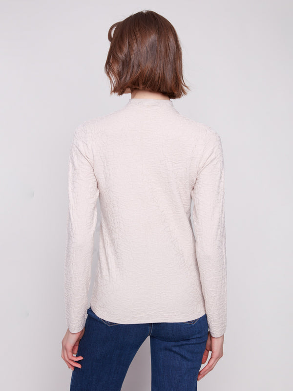 Elegant slim-fit oat sweater teamed with classic blue jeans, perfect for any casual outing by Charlie B.