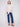 Mock neck oat sweater combined with blue jeans, offering a contemporary slim fit style by Charlie B.