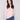 Ballet pink sweater featuring a mock neck and blue jeans, highlighting its slim fit silhouette by Charlie B.