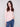 Ballet pink sweater featuring a mock neck and blue jeans, highlighting its slim fit silhouette by Charlie B.