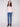 Textured ballet pink sweater paired with blue jeans, showcasing its elegant mock neck design by Charlie B.