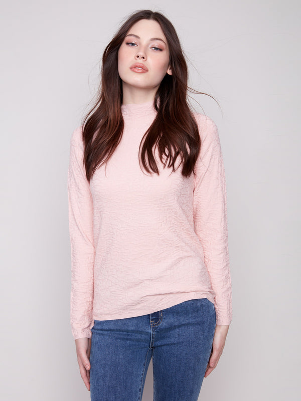 Ballet pink slim fit sweater with a textured finish and blue jeans ensemble by Charlie B.