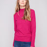 Hibiscus sweater with textured fabric and long sleeves, paired elegantly with blue jeans by Charlie B.