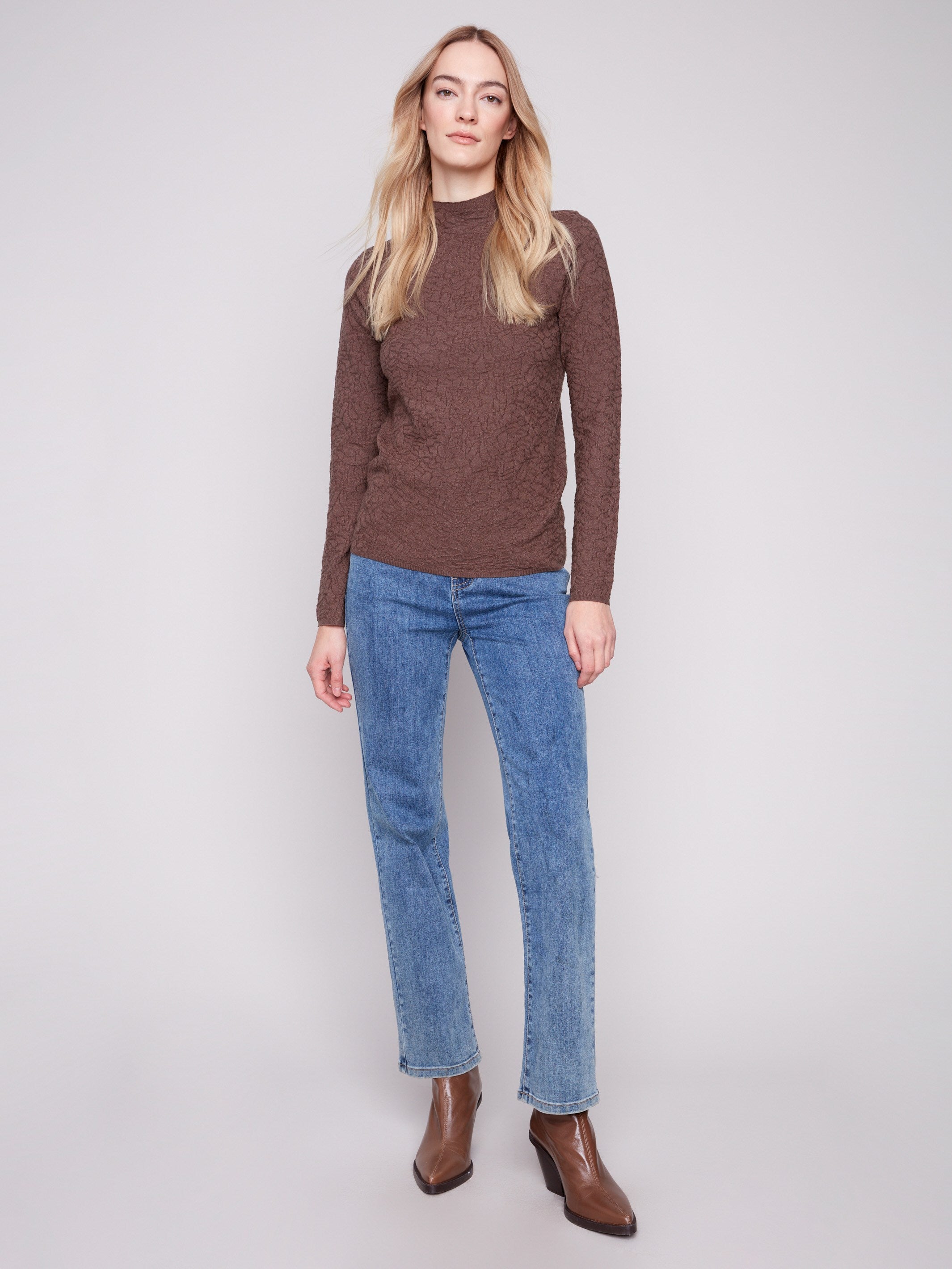 Textured mocha sweater styled elegantly with blue jeans, showcasing a modern fashion statement by Charlie B.