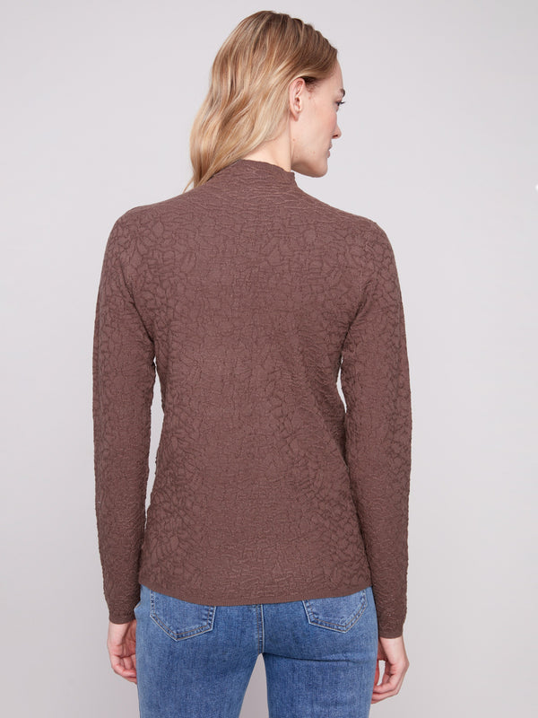 Long-sleeve mocha sweater with textured fabric, complemented by casual blue jeans for an effortless look by Charlie B.
