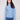 Oxford blue sweater featuring a mock neck paired with classic blue jeans, showcasing its elegant design by Charlie B.