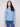 Oxford blue sweater featuring a mock neck paired with classic blue jeans, showcasing its elegant design by Charlie B.