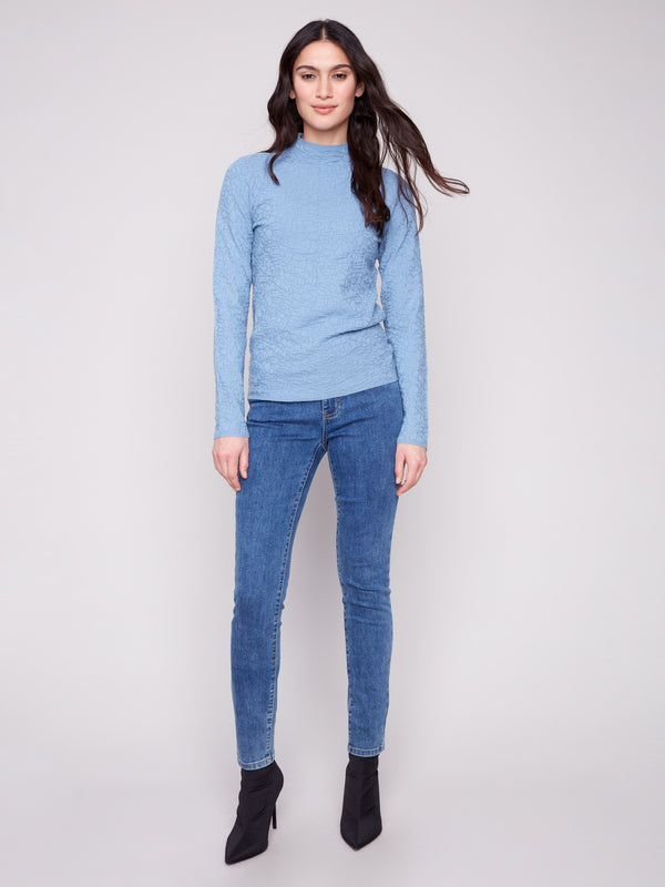 Textured fabric in an Oxford blue hue, this long-sleeve sweater complements the sleek denim look by Charlie B.
