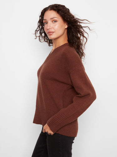 This sweater showcases a trendy drop shoulder design, offering a relaxed and comfortable fit. By Charlie B.