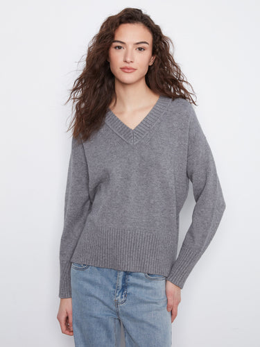 Grey knit sweater featuring a stylish V-neckline and ribbed cuffs, perfect for cozy days by Charlie B.