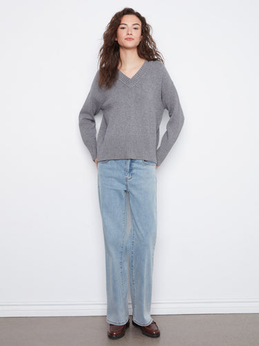 A versatile grey V-neck sweater with subtle ribbed accents, ideal for layering in cooler weather by Charlie B.