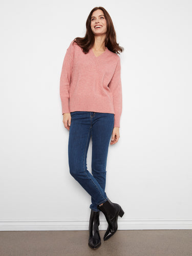 Featuring a drop shoulder design, this pink sweater adds effortless elegance by Charlie B.