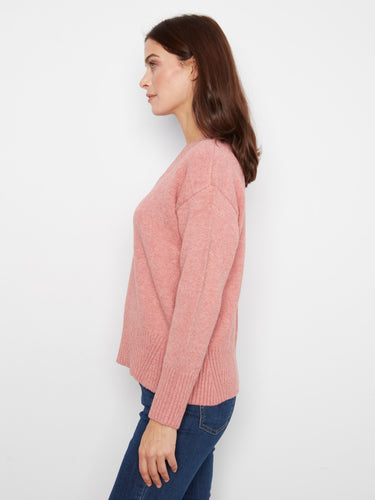 Ribbed details enhance the cozy appeal of this charming pink sweater by Charlie B.