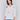 White V-neck knit top with colorful floral appliqués, featuring drop shoulders, by Charlie B.